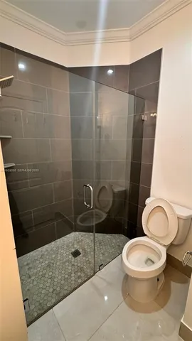 a bathroom with a toilet and a shower