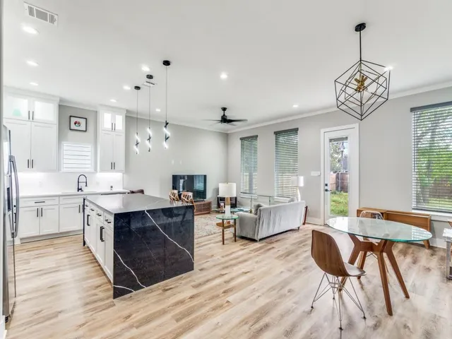 a large kitchen with a table and chairs in it