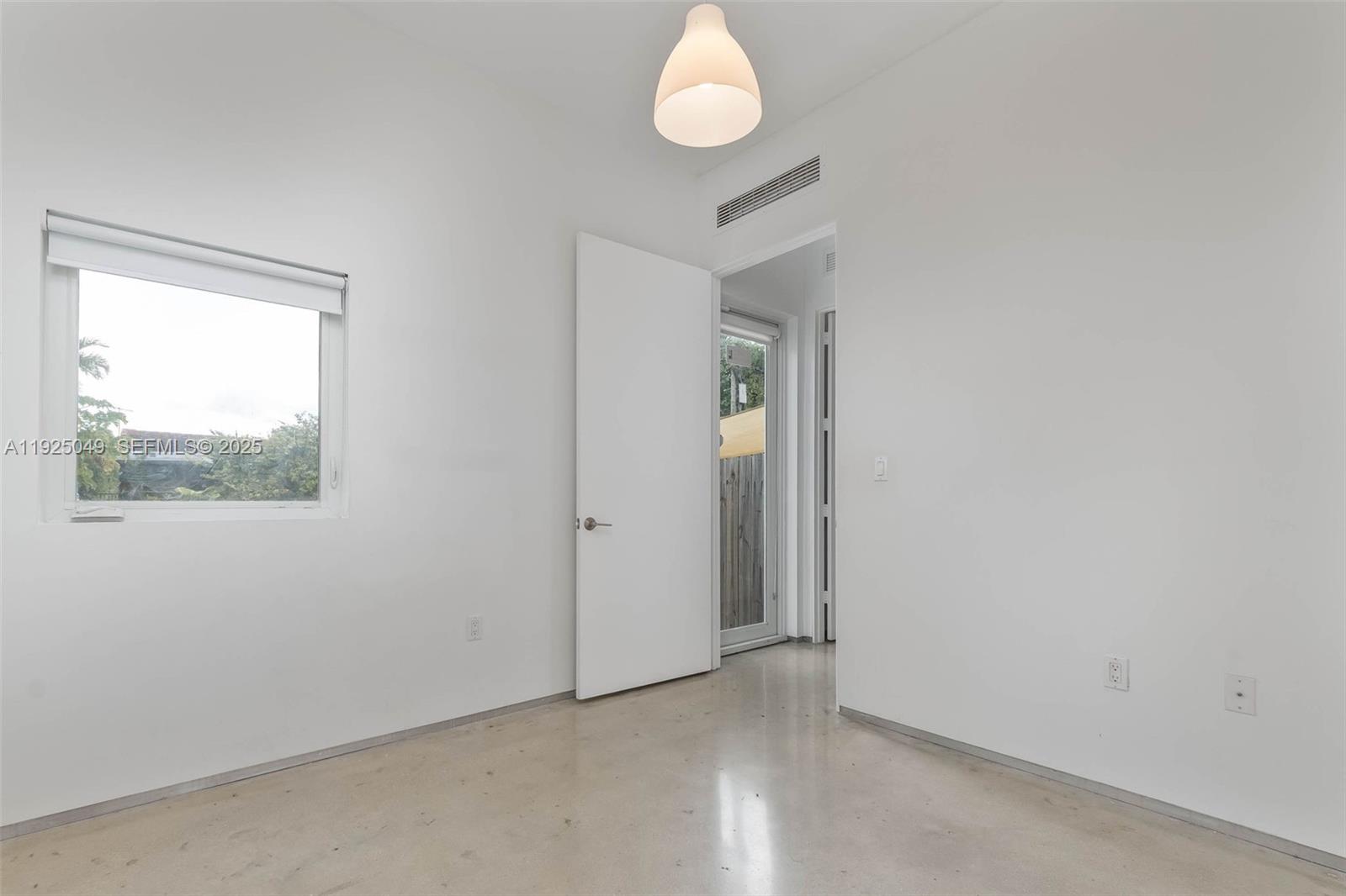 3660 Southwest 24th Terrace, Unit 3660 Miami, FL 33145 - Photo 15 of 21 an empty room with wooden floor and windows