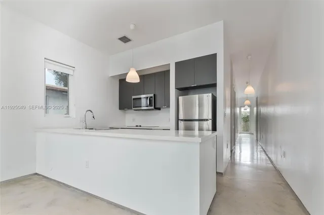 a view of a kitchen from the hallway