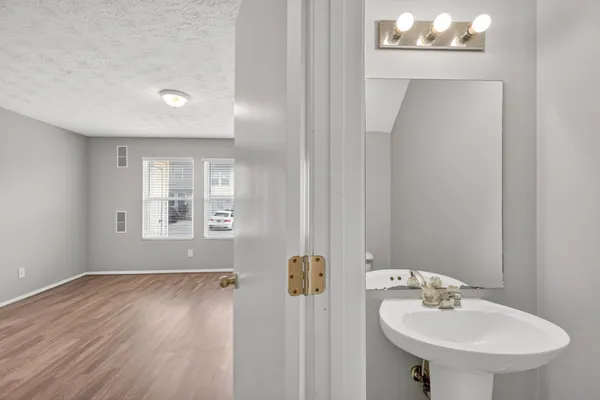 a bathroom with a sink a mirror and a window