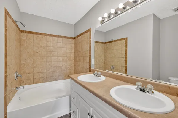 a bathroom with a double vanity sink and a bathtub