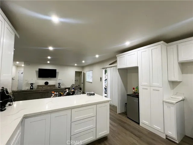 a kitchen with stainless steel appliances a refrigerator sink and microwave
