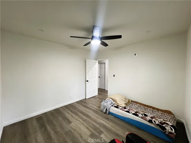 a bedroom with a bed and a ceiling fan