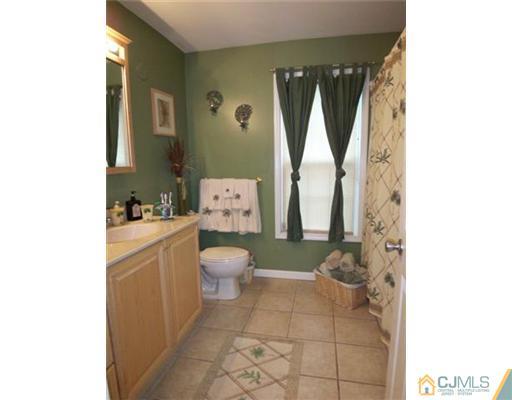 98 East Cliff Road Colonia, NJ 07067 - Photo 14 of 23 a bathroom with a toilet sink and mirror