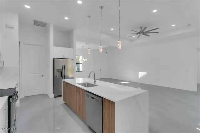 a large kitchen with a large counter top appliances and cabinets