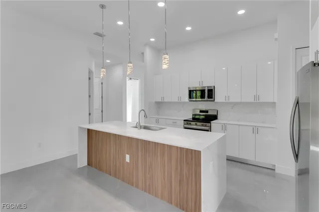 a kitchen with a sink cabinets and stainless steel appliances