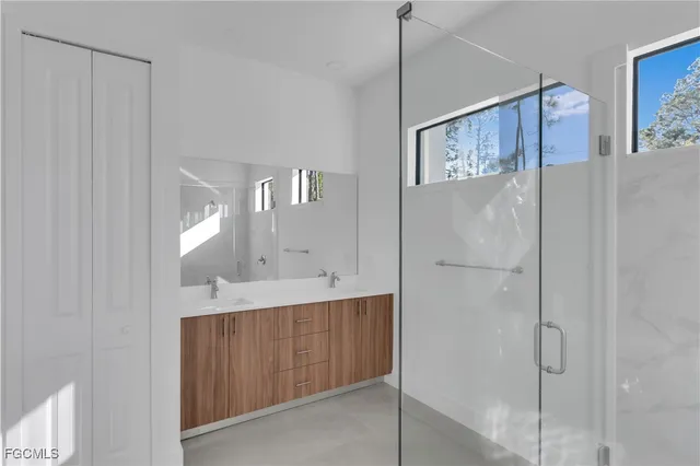 a spacious bathroom with a double vanity sink and a mirror
