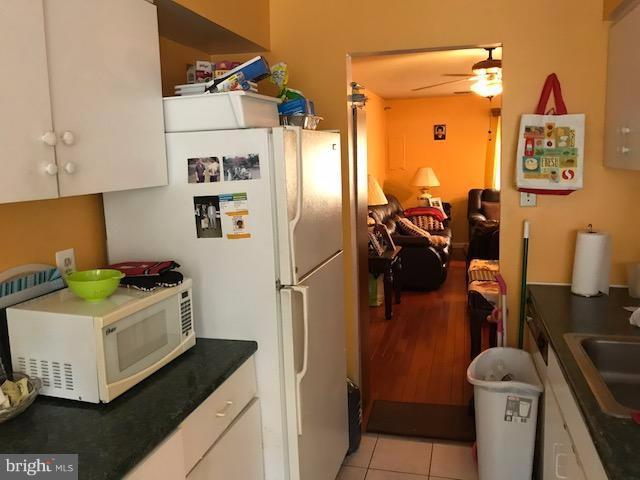 3424 Bruton Parish Way, Unit 25169 Silver Spring, MD 20904 - Photo 2 of 7 a kitchen with a refrigerator and a stove