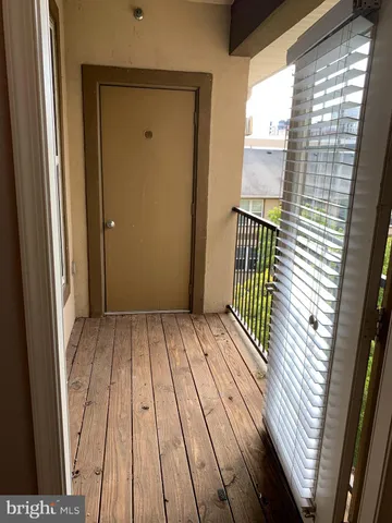 a view of balcony with wooden floor