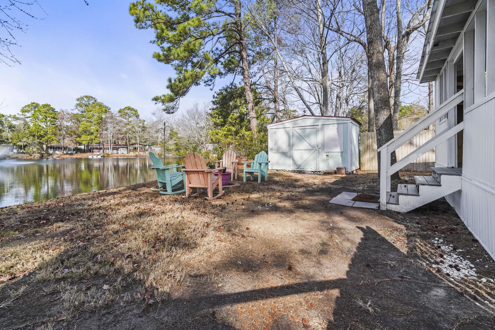 45 Shamrock Circle Murrells Inlet, SC 29576 - Photo 11 of 32 View of yard with a water view and a storage shed