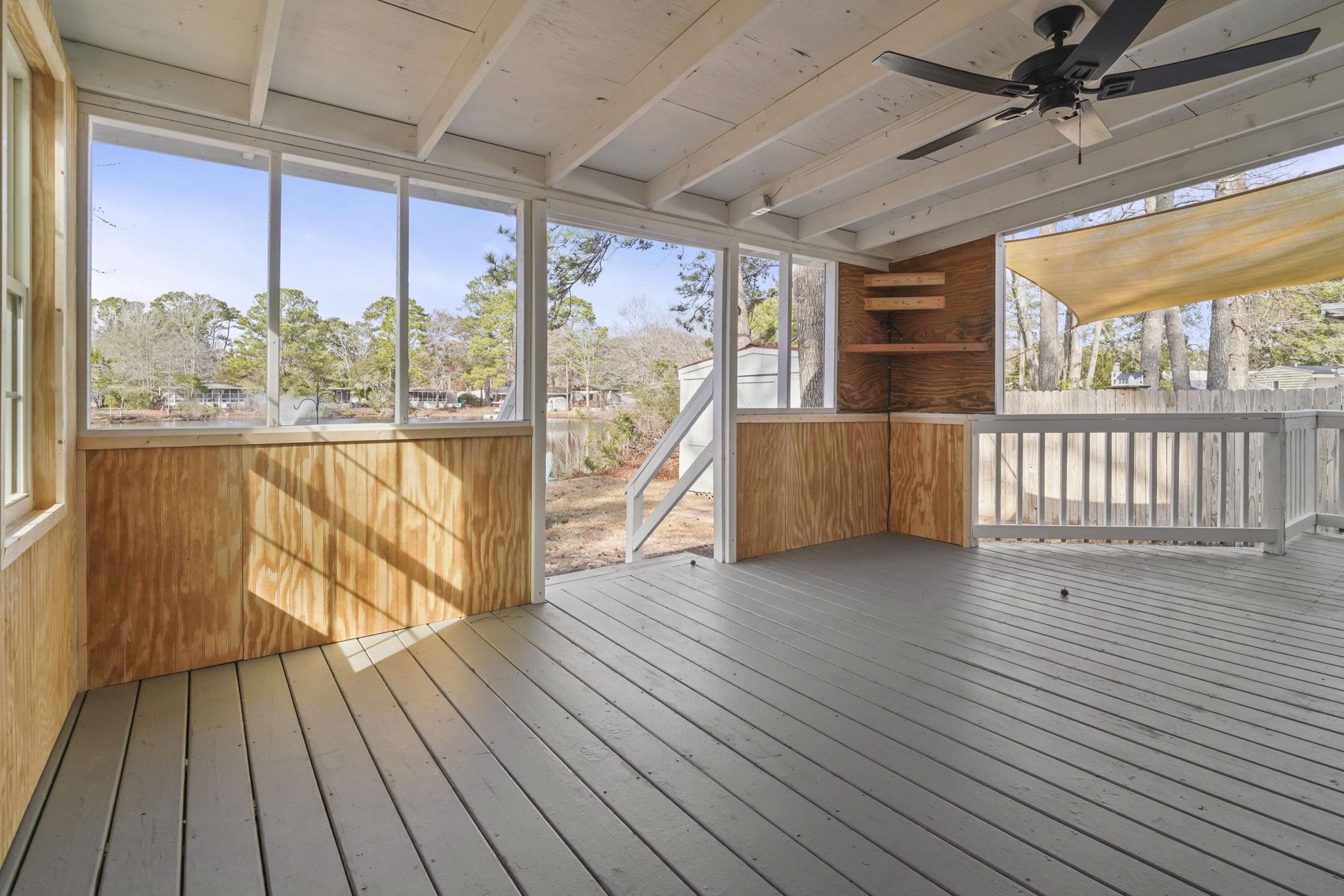 45 Shamrock Circle Murrells Inlet, SC 29576 - Photo 15 of 32 Unfurnished sunroom with a deck and ceiling fan