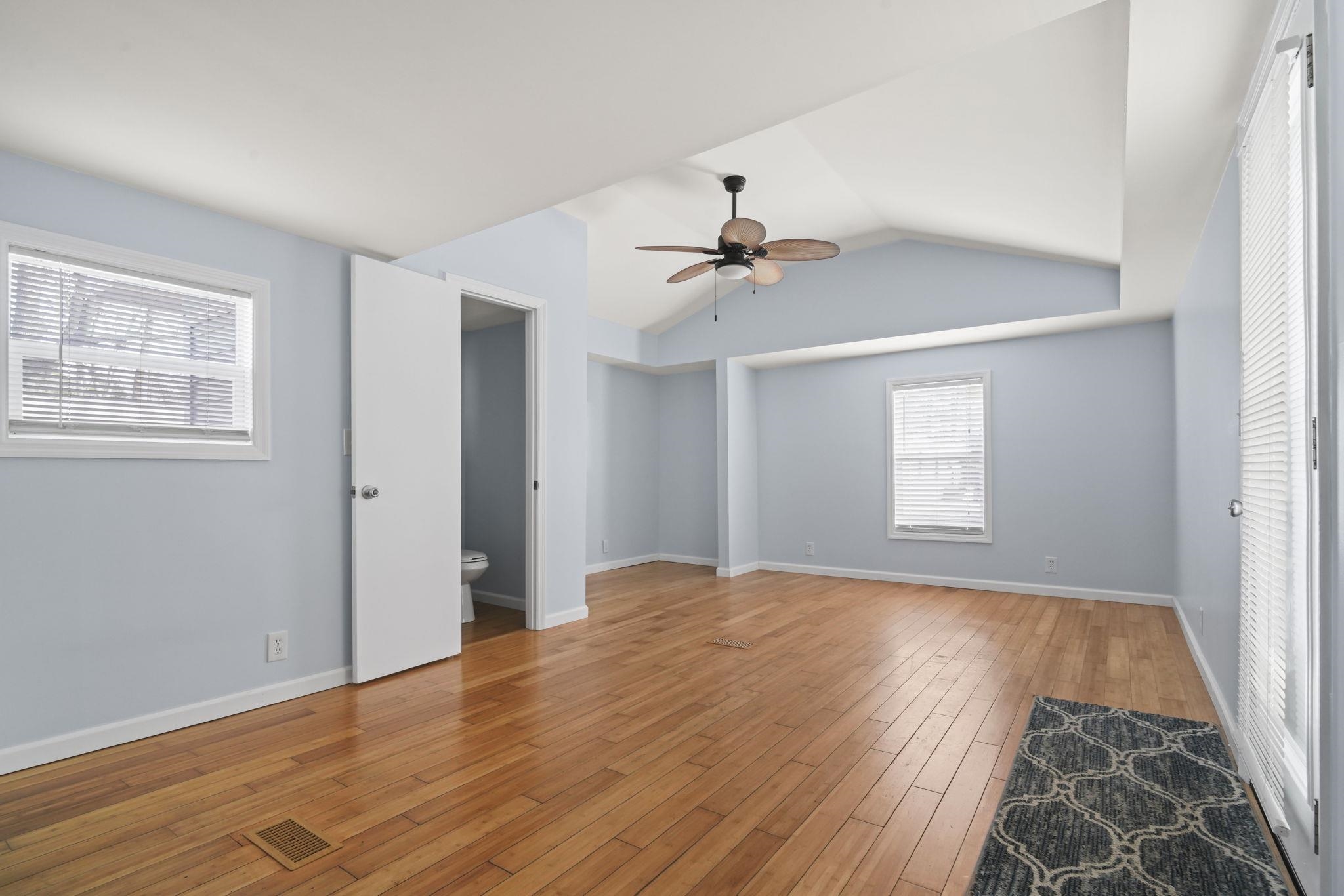 45 Shamrock Circle Murrells Inlet, SC 29576 - Photo 17 of 32 Unfurnished bedroom with lofted ceiling, light wood finished floors, a ceiling fan, and ensuite bathroom