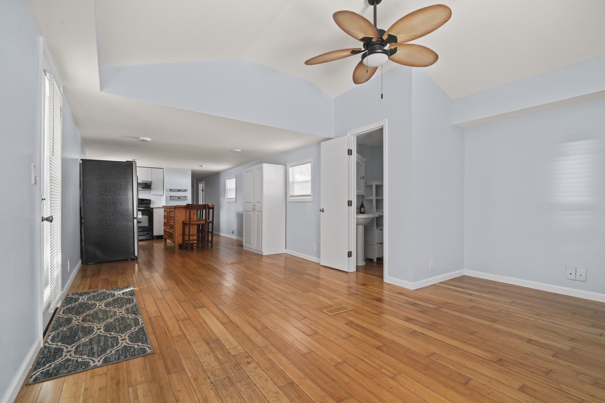 45 Shamrock Circle Murrells Inlet, SC 29576 - Photo 19 of 32 Unfurnished living room featuring hardwood / wood-style floors, ceiling fan, and lofted ceiling