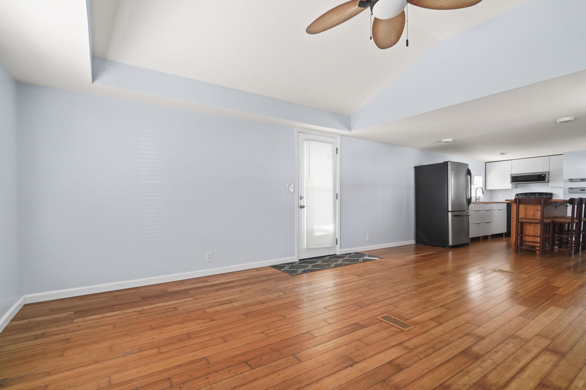 45 Shamrock Circle Murrells Inlet, SC 29576 - Photo 20 of 32 Unfurnished living room with ceiling fan, light wood-style floors, and lofted ceiling
