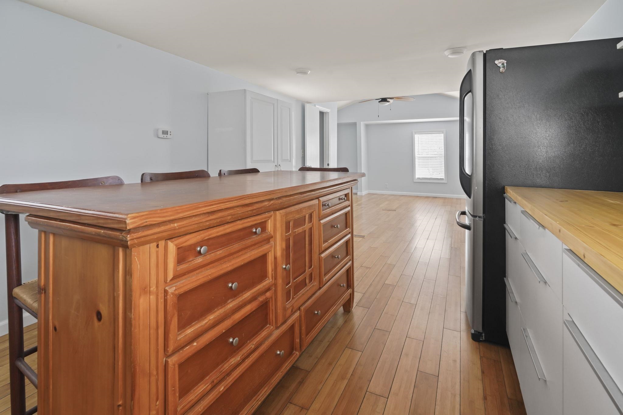 45 Shamrock Circle Murrells Inlet, SC 29576 - Photo 25 of 32 Kitchen featuring butcher block counters, a kitchen bar, freestanding refrigerator, and light wood-style floors