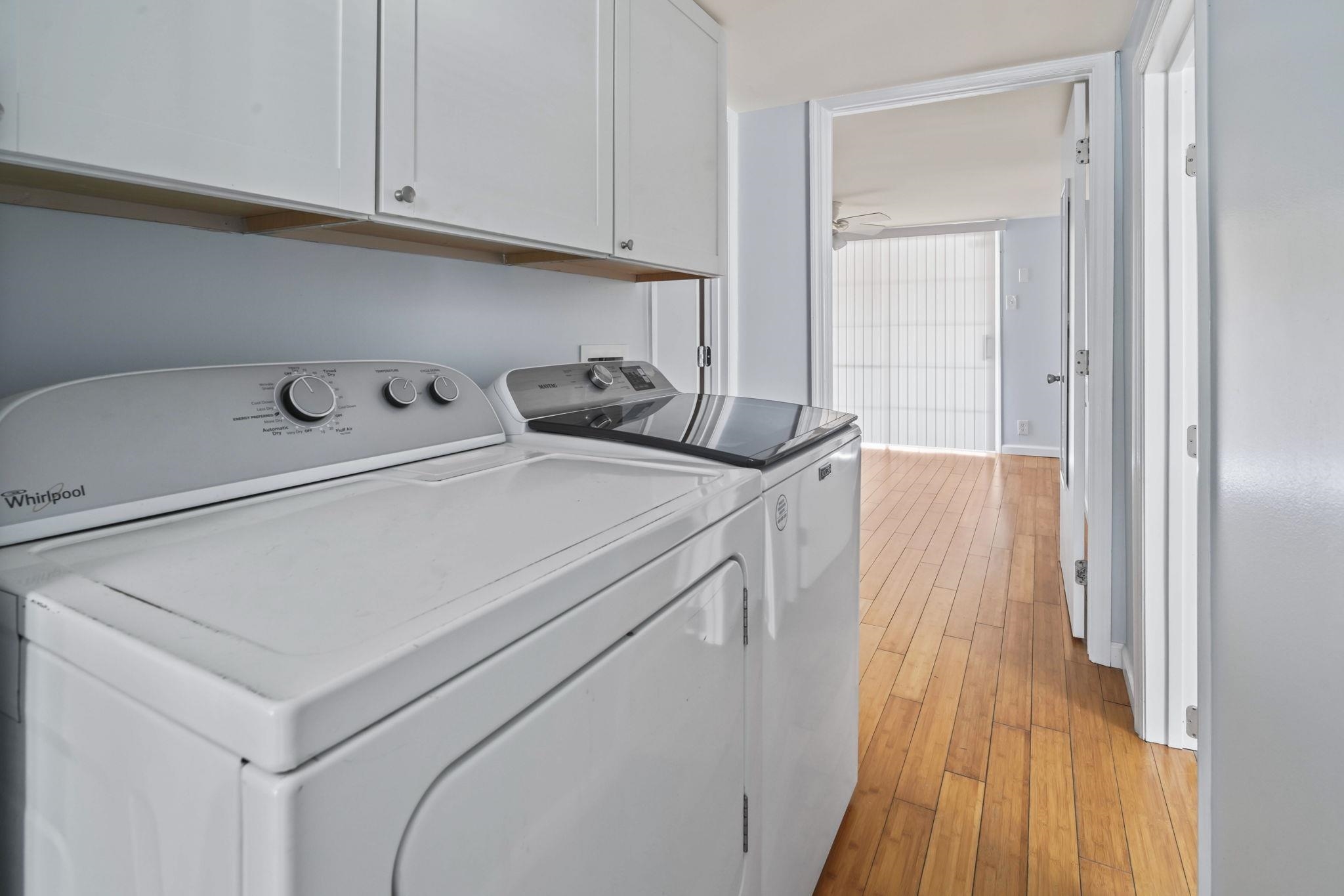 45 Shamrock Circle Murrells Inlet, SC 29576 - Photo 26 of 32 Laundry area with light wood-style flooring, cabinet space, washing machine and dryer, and a ceiling fan
