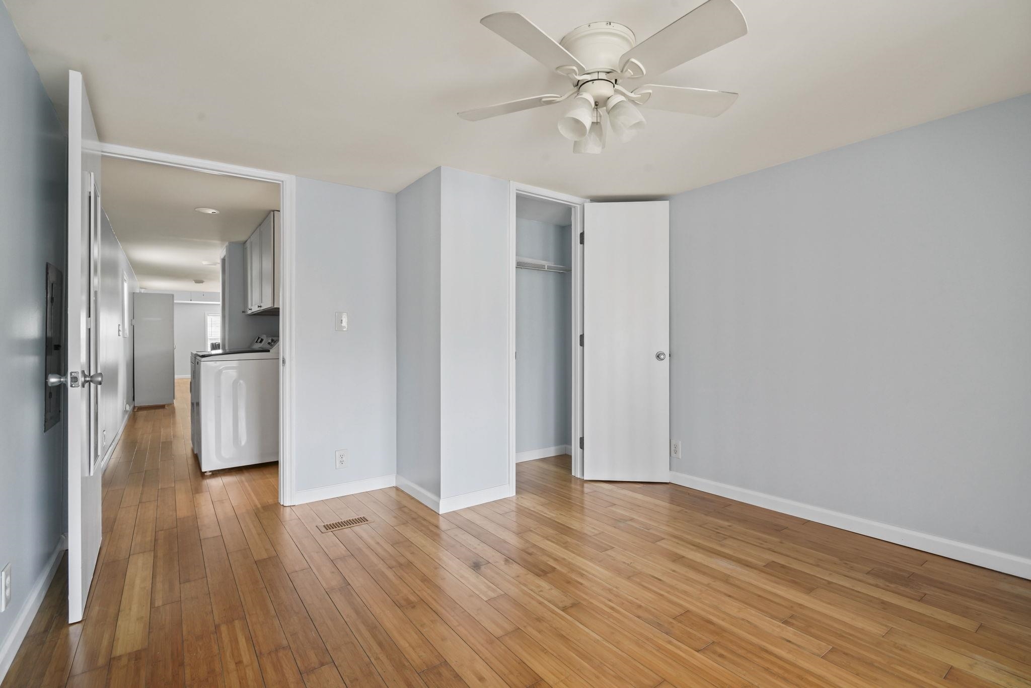 45 Shamrock Circle Murrells Inlet, SC 29576 - Photo 30 of 32 Unfurnished bedroom featuring washer / clothes dryer, light wood-type flooring, a closet, and ceiling fan
