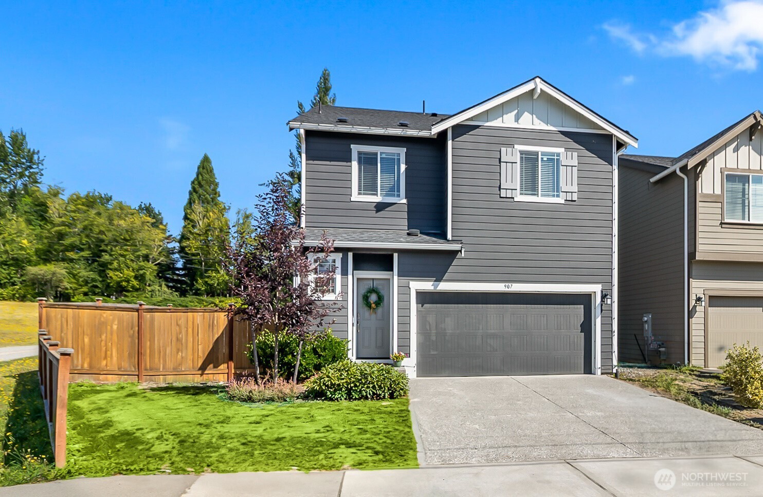 a front view of a house with a yard and garage