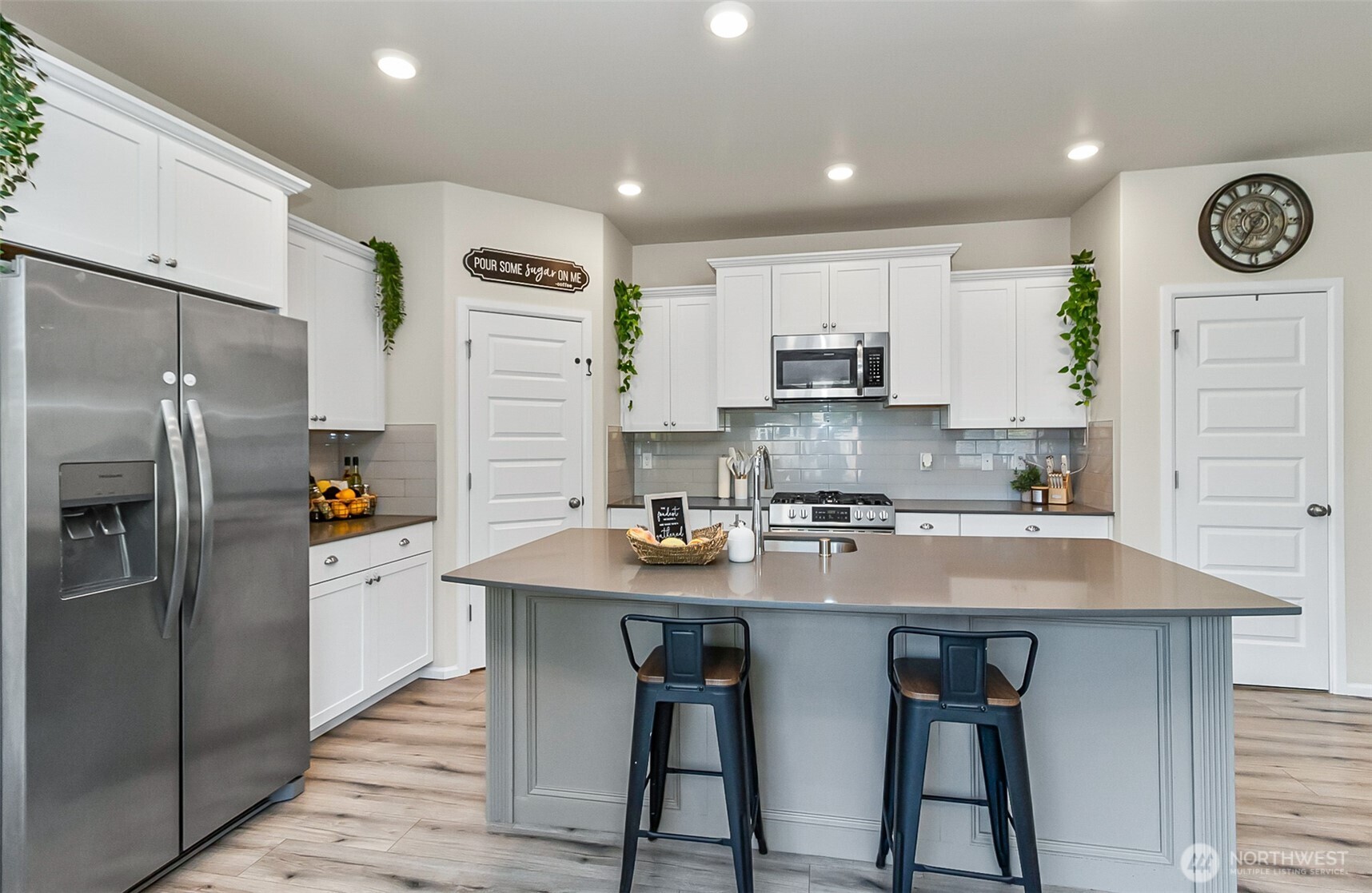 907 Bryant Road Sultan, WA 98294 - Photo 11 of 40 a kitchen with stainless steel appliances granite countertop a refrigerator a stove a sink and a refrigerator with wooden floor