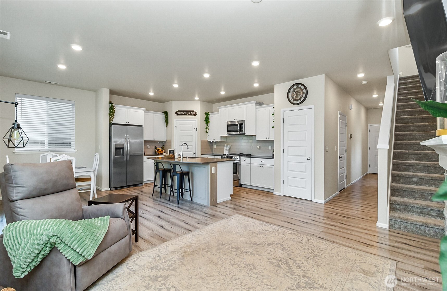 907 Bryant Road Sultan, WA 98294 - Photo 15 of 40 a kitchen with a refrigerator and a living room