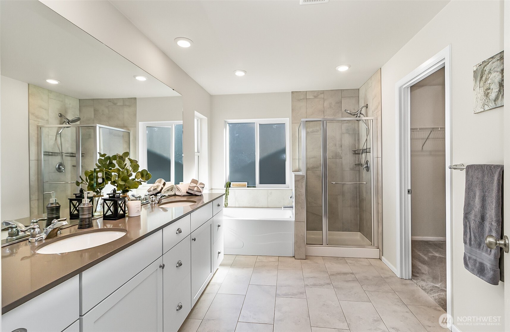 907 Bryant Road Sultan, WA 98294 - Photo 27 of 40 a large bathroom with a double vanity sink a large mirror and a shower