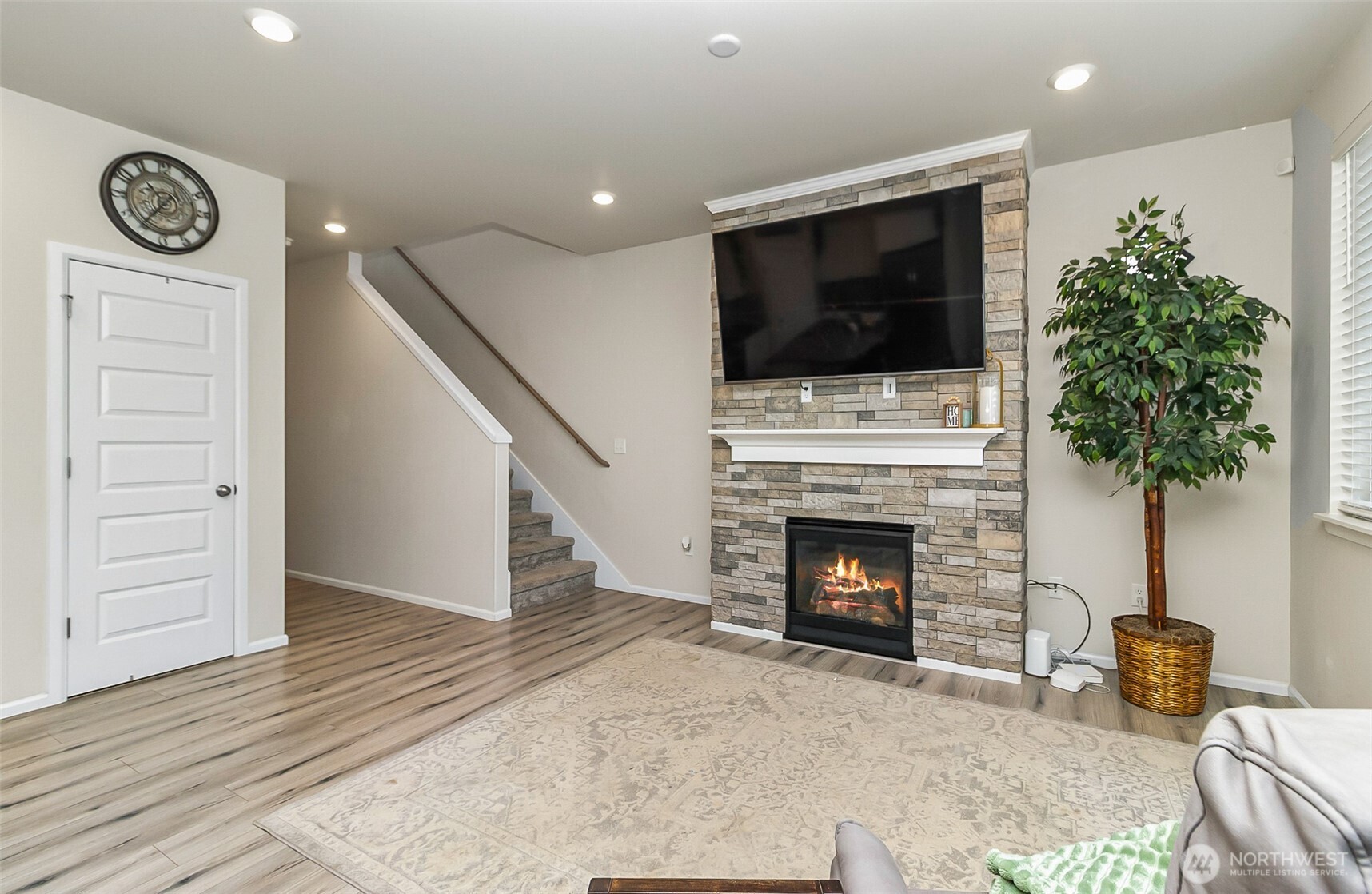 907 Bryant Road Sultan, WA 98294 - Photo 7 of 40 a living room with furniture a flat screen tv and a fireplace