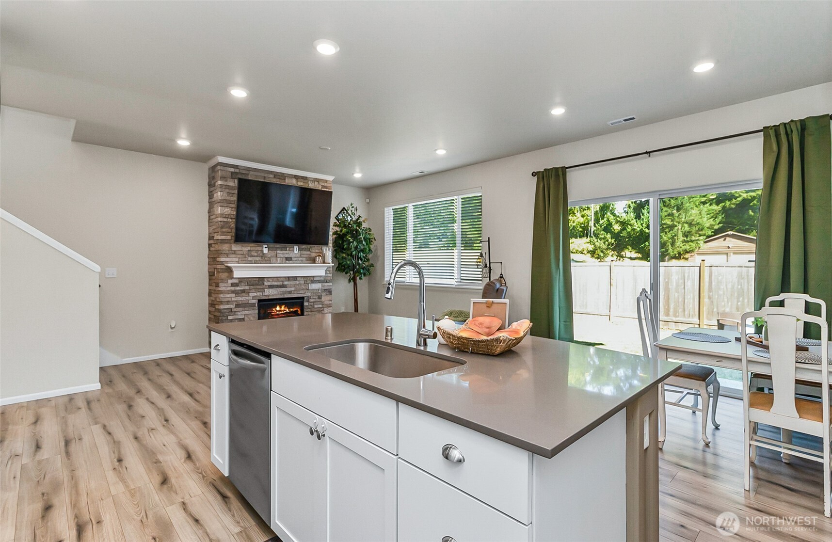 907 Bryant Road Sultan, WA 98294 - Photo 10 of 40 a kitchen with stainless steel appliances granite countertop a sink a stove and a wooden floors