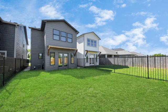 an aerial view of residential houses with outdoor space and swimming pool