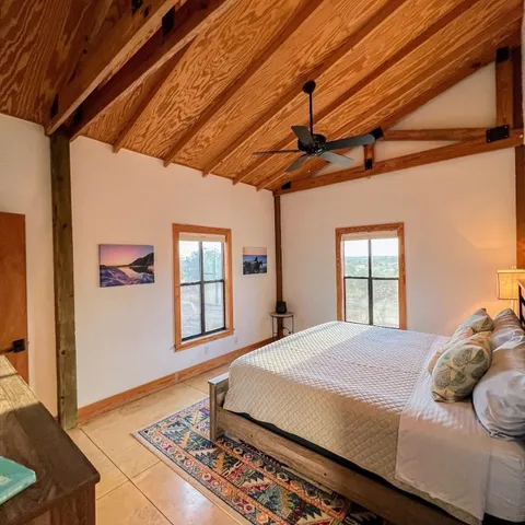 a bedroom with a large bed and a window