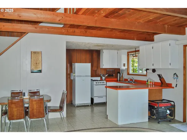 a kitchen with stainless steel appliances granite countertop a sink a refrigerator and a stove
