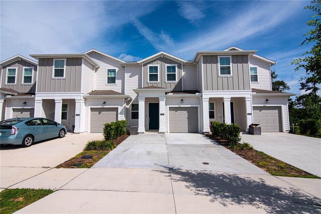 2340 Brook Marsh Loop Kissimmee, FL 34747 - Photo 12 of 53 a front view of a house with a yard and garage