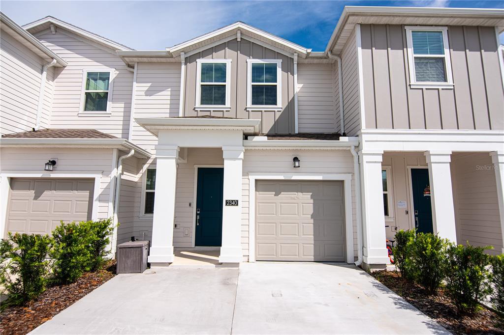 2340 Brook Marsh Loop Kissimmee, FL 34747 - Photo 15 of 53 a front view of a house with a garden