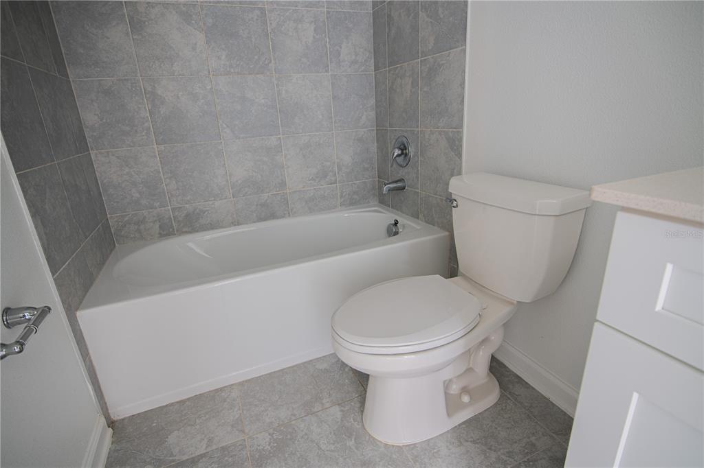 2340 Brook Marsh Loop Kissimmee, FL 34747 - Photo 36 of 53 a white toilet sitting next to a bath tub
