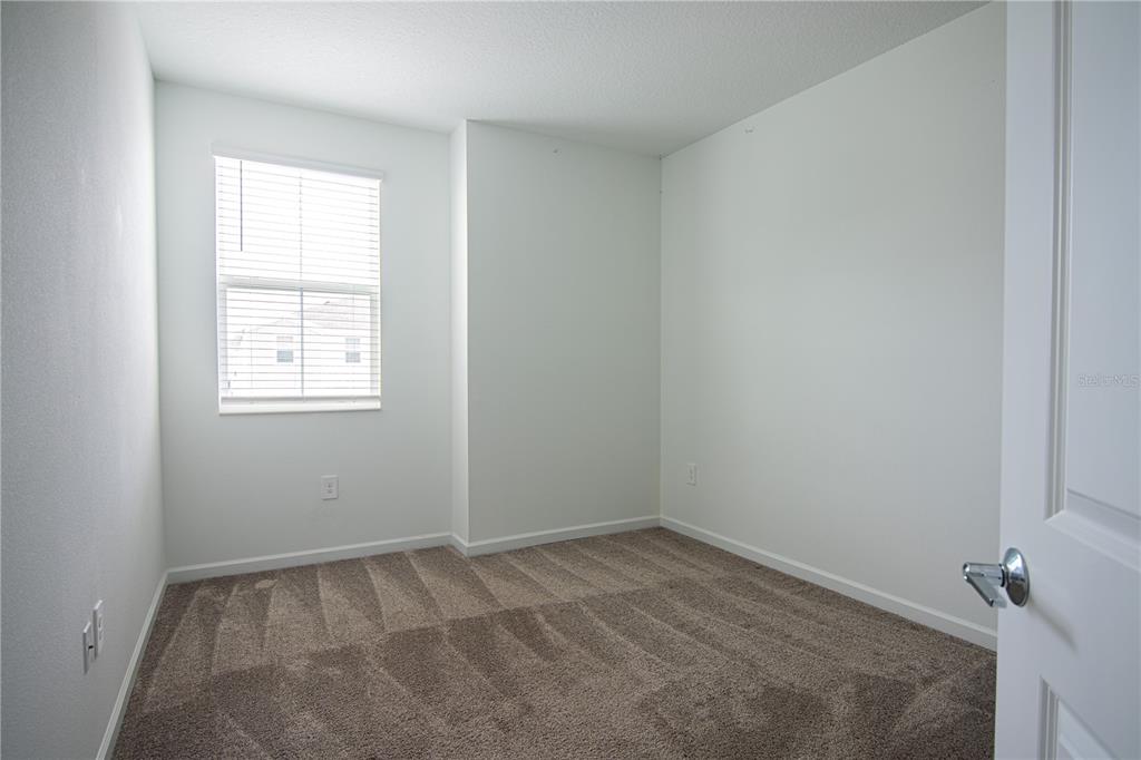 2340 Brook Marsh Loop Kissimmee, FL 34747 - Photo 39 of 53 an empty room with a window
