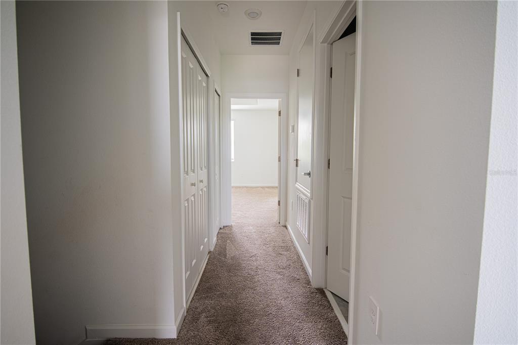 2340 Brook Marsh Loop Kissimmee, FL 34747 - Photo 44 of 53 a view of a hallway with a glass door