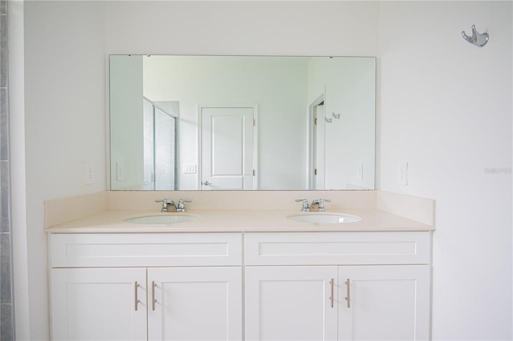 2340 Brook Marsh Loop Kissimmee, FL 34747 - Photo 50 of 53 a bathroom with a sink and a mirror