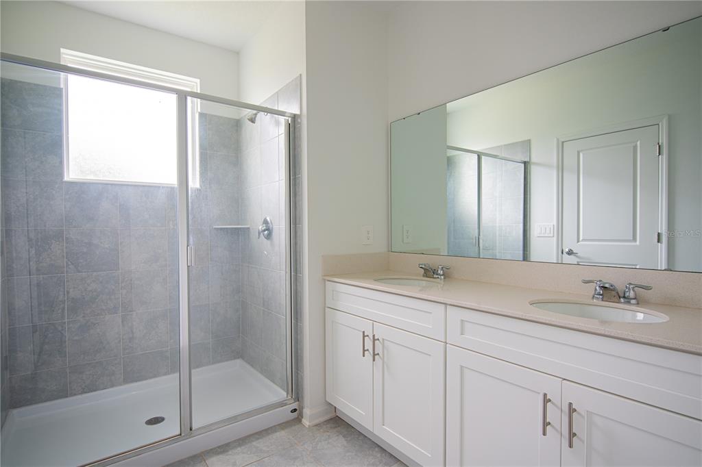 2340 Brook Marsh Loop Kissimmee, FL 34747 - Photo 51 of 53 a bathroom with a granite countertop sink mirror and double