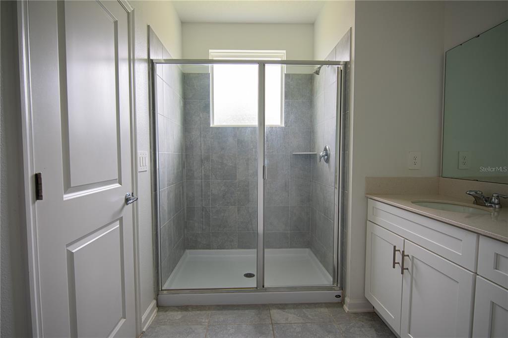 2340 Brook Marsh Loop Kissimmee, FL 34747 - Photo 52 of 53 a bathroom with a shower and a sink