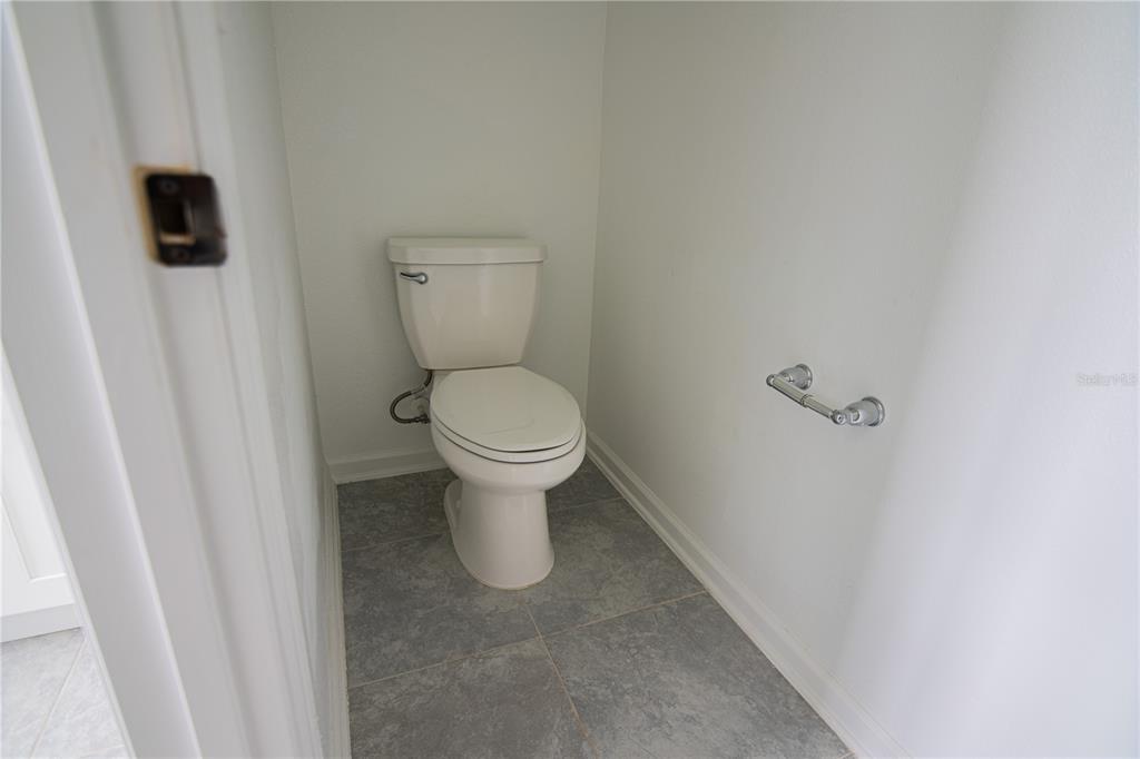 2340 Brook Marsh Loop Kissimmee, FL 34747 - Photo 53 of 53 a white toilet sitting next to a sink
