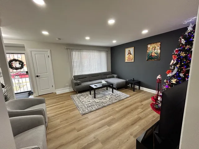 a living room with furniture and flowers