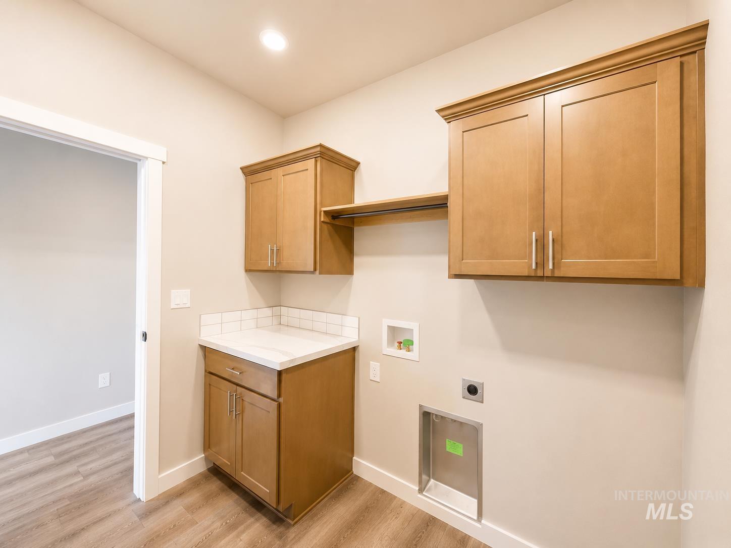 983 Quartz Road Kimberly, ID 83341 - Photo 18 of 18 Light wood-finish cabinetry, white countertop, white subway tile backsplash, recessed ceiling lighting, and wood-finish flooring