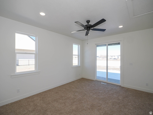 3938 North Wood Road Eagle Mountain, UT 84005 - Photo 16 of 55 Spare room featuring dark carpet, recessed lighting, and ceiling fan