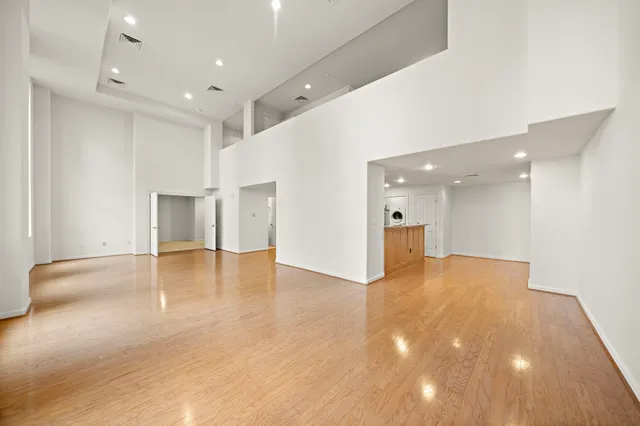 a view of an empty room with wooden floor