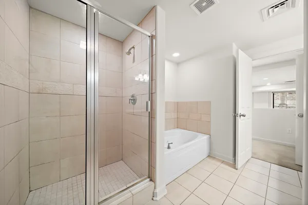 a bathroom with a bathtub and shower
