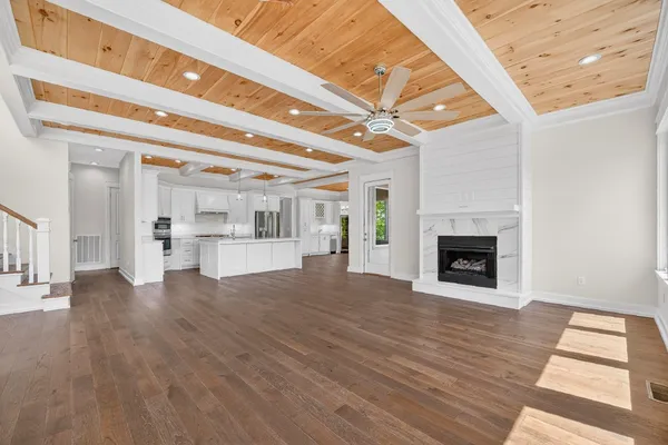 a view of empty room with wooden floor and fireplace