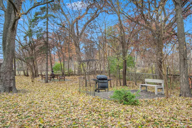 a backyard of a house with table and chairs