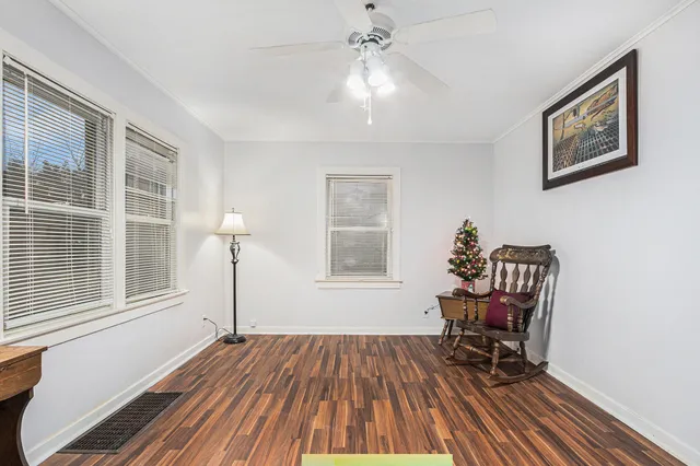 a view of a livingroom with wooden floor and furniture
