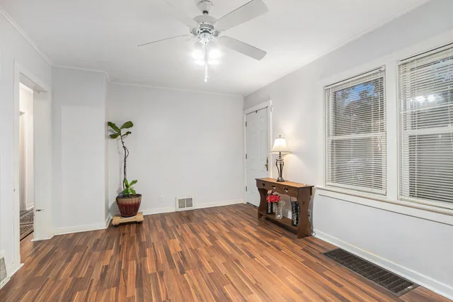 wooden floor in an empty room with a window