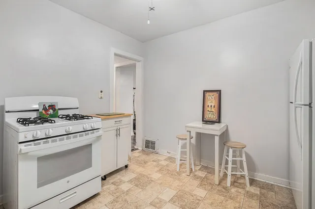a kitchen with a stove and white cabinets